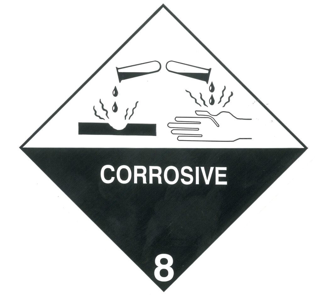 DOT Class 8 corrosive hazard placard, white over black with liquid corroding hand and metal symbol